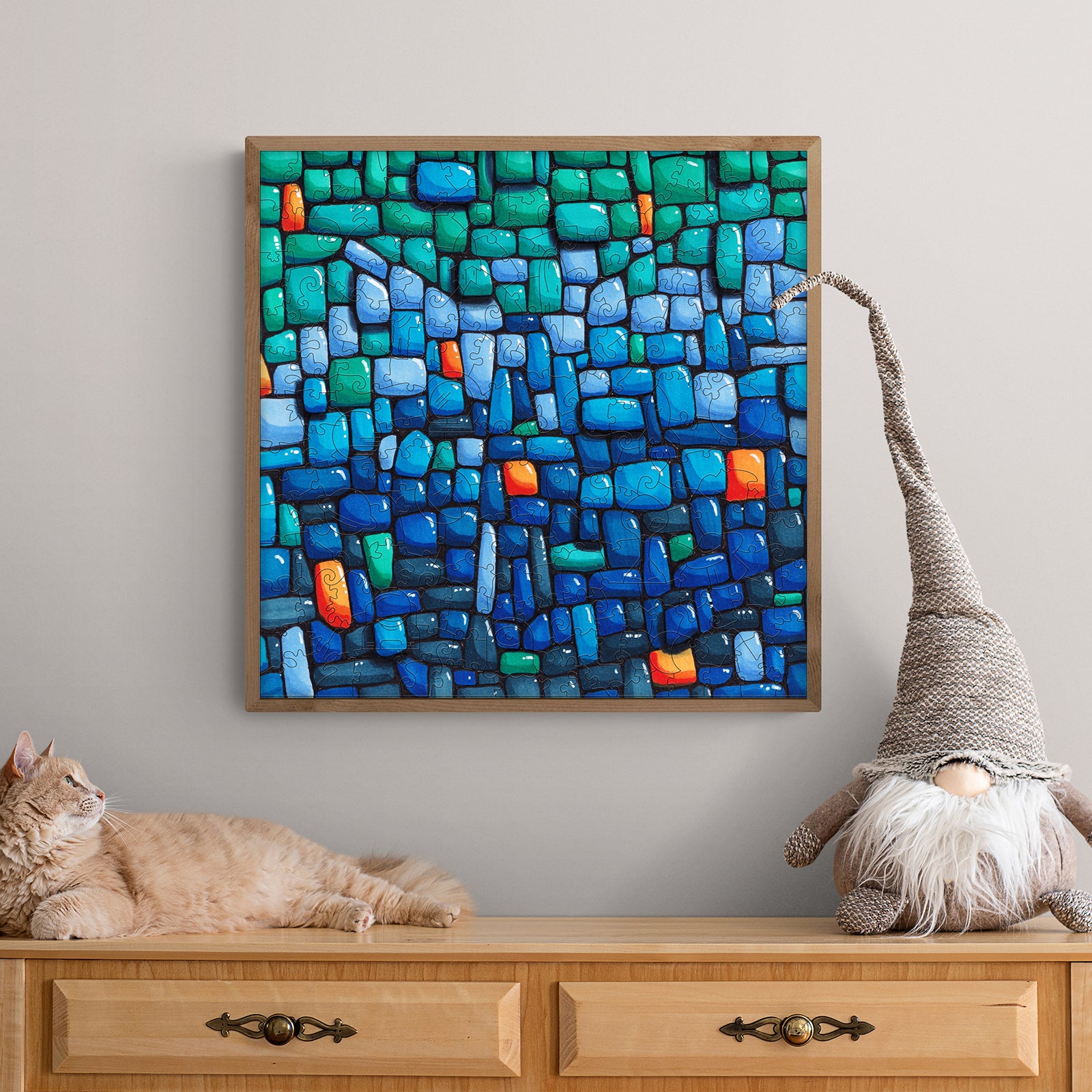 Blue Wall artwork by Erin Desjardine, featuring vibrant blues and greens, displayed on a stylish wood dresser.